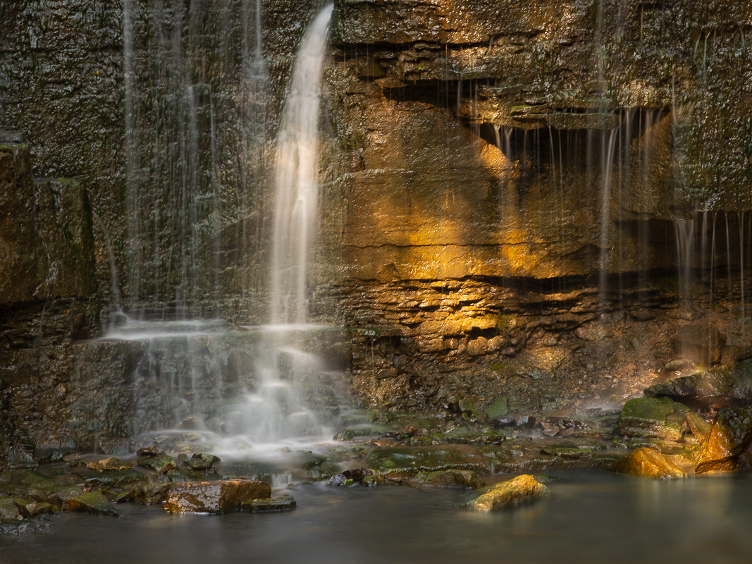 2 Serene waterfall with golden light.